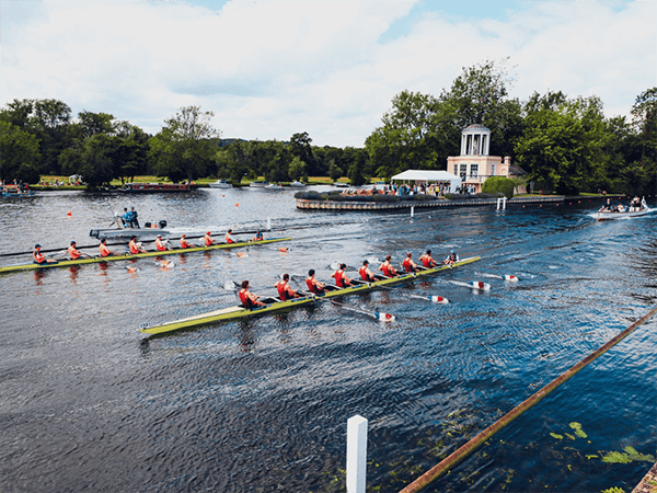 rowing teams race down the river thames at henley royal regatta